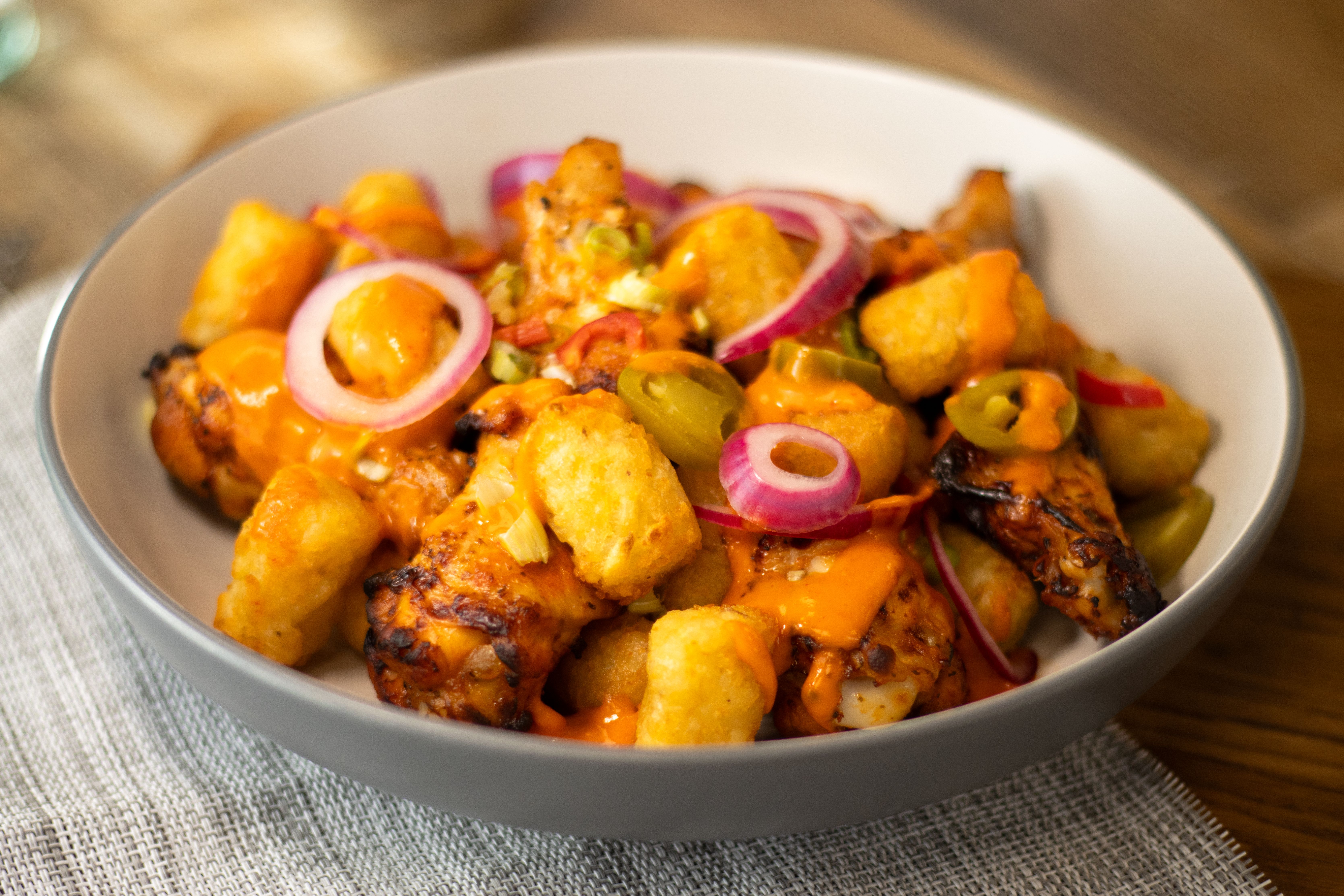 Loaded Hash Brown Bites with Buffalo Wings & Hot Sauce